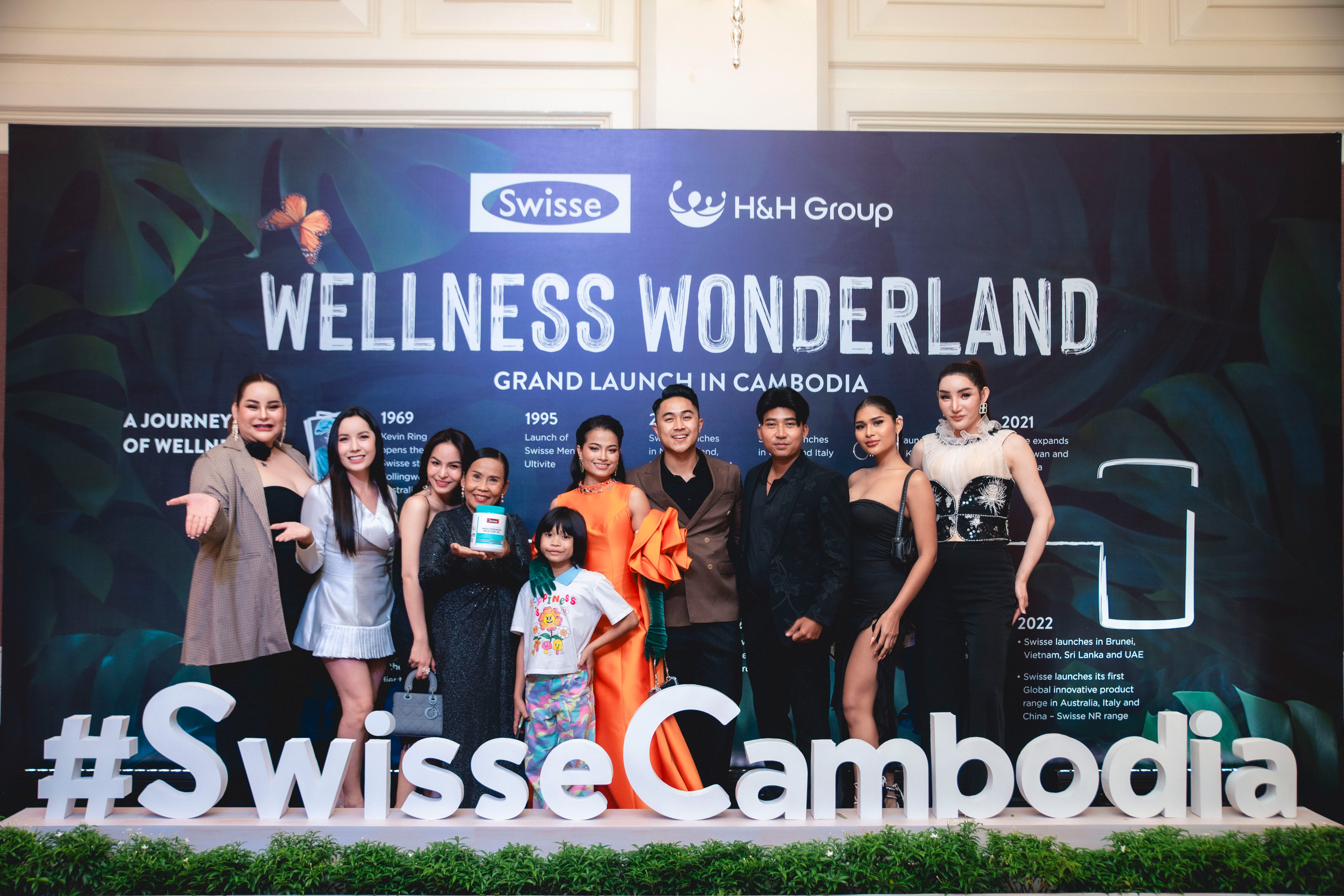 Swisse Cambodia launch guests in front of the event identity